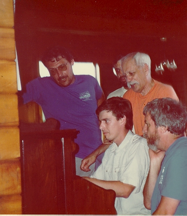Photo of group singing around the organ